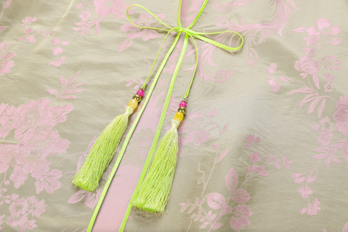 Chinese Silky Phoenix Brocade Abaya (Neon Green) — close-up of neon-green ties and tassels against pink patterned brocade