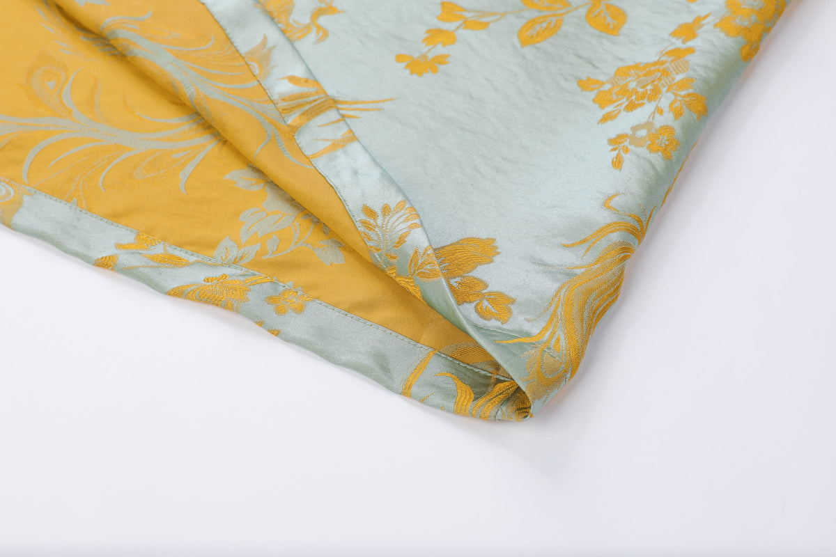 Chinese Silky Phoenix Brocade Abaya (Neon Orange) — folded hem detail showing patterned brocade and its reverse