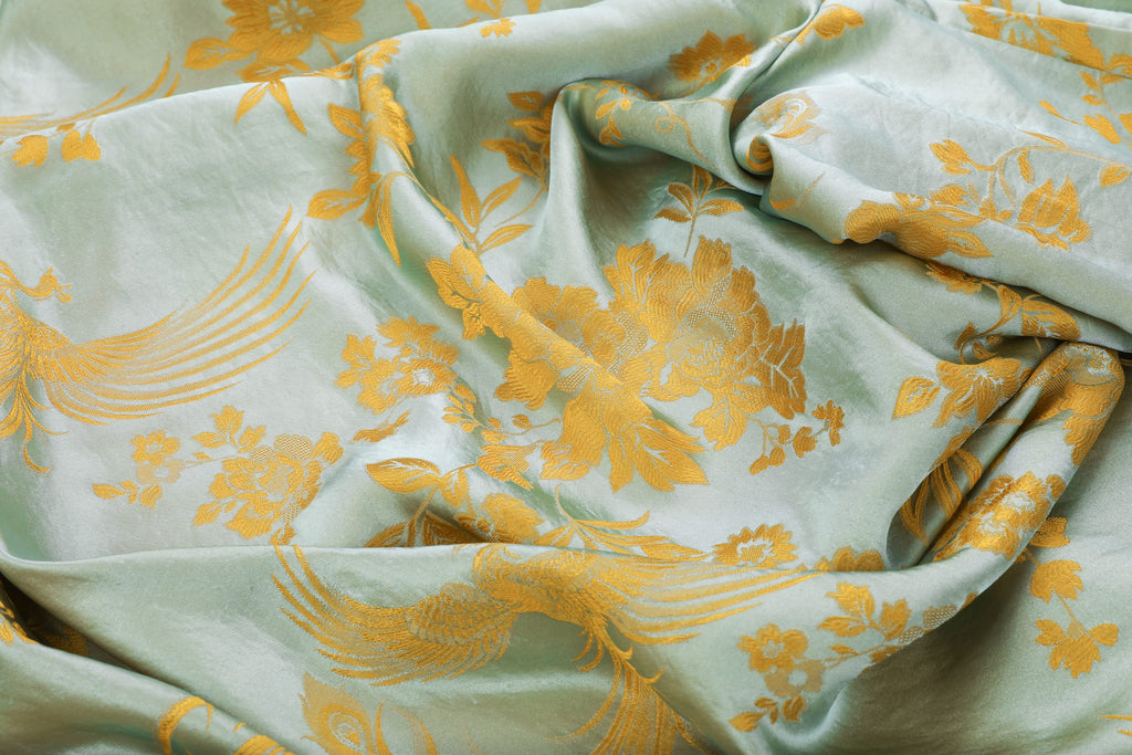 Chinese Silky Phoenix Brocade Abaya (Neon Orange) — close-up of draped brocade with gold-toned woven motifs